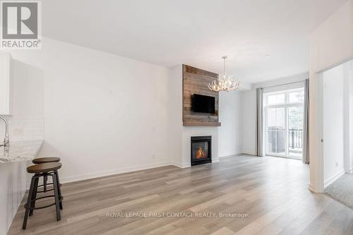 #114 -40 Horseshoe Blvd, Oro-Medonte, ON - Indoor Photo Showing Living Room With Fireplace