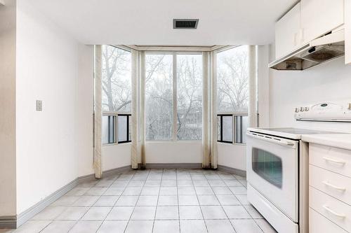 Bay Window Kitchen Alcove for morning coffee; overlooks greenspace and meandering creek. - 2121 Lakeshore Road|Unit #307, Burlington, ON - Indoor Photo Showing Kitchen