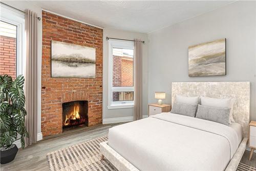 291 Emerald Street N|Unit #Main, Hamilton, ON - Indoor Photo Showing Bedroom With Fireplace