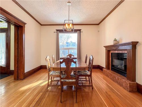318 16Th Street, Brandon, MB - Indoor Photo Showing Dining Room With Fireplace