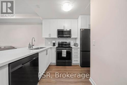 #215 -2750 King St E, Hamilton, ON - Indoor Photo Showing Kitchen With Double Sink