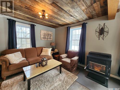 148 Grenfell Beach, Crooked Lake, SK - Indoor Photo Showing Living Room With Fireplace