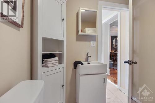 Powder Room/Laundry Room with Cabinetry and a folding counter - 517 St Lawrence Street, Merrickville, ON - Indoor Photo Showing Laundry Room