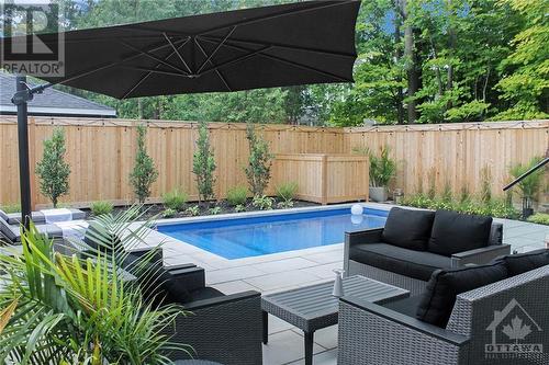 Backyard oasis is fully lanscaped, with irrigation system and lighting - 434 Kenwood Avenue, Ottawa, ON - Outdoor With In Ground Pool