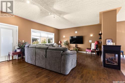 6037 Eagles Cove, Regina, SK - Indoor Photo Showing Living Room With Fireplace