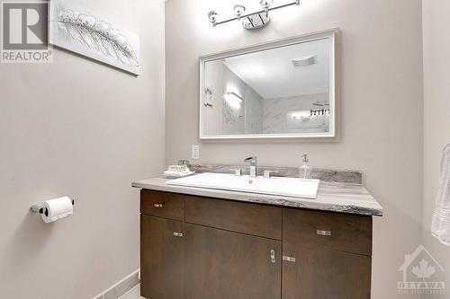 And new vanity top, Updates also include new mirror and new vanity light. - 330 Royal Fern Way, Ottawa, ON - Indoor Photo Showing Bathroom