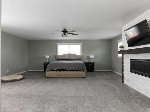 1230 Elwyn Road, Kelowna, BC - Indoor Photo Showing Bedroom With Fireplace
