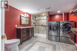 full bathroom in the basement, with laundry. - 