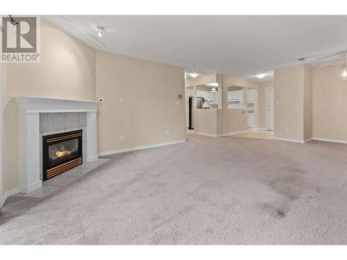 2265 Atkinson Street Sw Unit# 405, Penticton, BC - Indoor Photo Showing Living Room With Fireplace