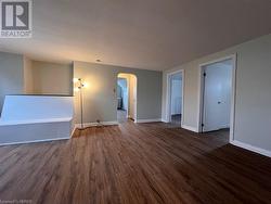 Unit 5 (3 bedroom) Living room, view of entry to kitchen and two of the bedrooms. - 