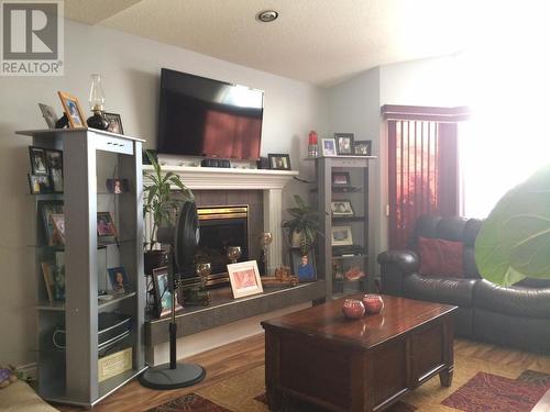 5520 Tuchodi Avenue, Fort Nelson, BC - Indoor Photo Showing Living Room With Fireplace