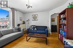 Unit 2- Living room features a large window for extra light. High baseboards and archways offers great character. - 