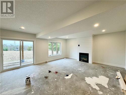 Basement family room with gas fireplace.   Carpet is included - 48 John Crescent, Chepstow, ON - Indoor With Fireplace
