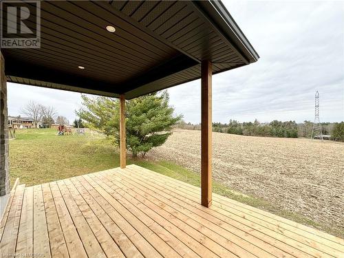 Partially covered rear deck backing onto an  A1 zoned property - 48 John Crescent, Chepstow, ON - Outdoor With Deck Patio Veranda