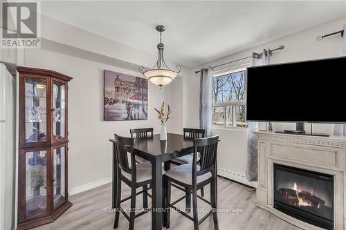 #217 -793 Colborne St, Brantford, ON - Indoor Photo Showing Dining Room With Fireplace