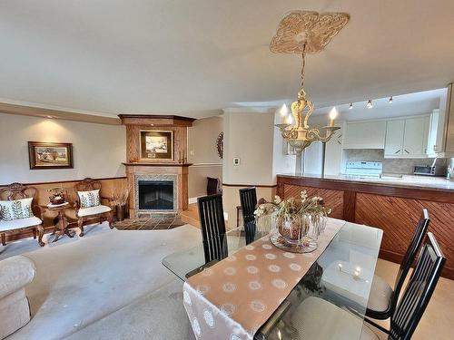 Salle familiale - 366 Rue Lulli, Laval (Laval-Des-Rapides), QC - Indoor Photo Showing Dining Room With Fireplace