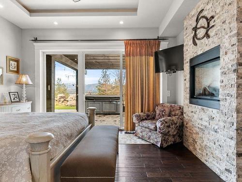 5500 Rockface Road, Kelowna, BC - Indoor Photo Showing Bedroom With Fireplace