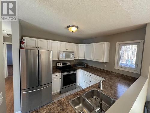 5320 Tamarack Crescent, Fort Nelson, BC - Indoor Photo Showing Kitchen With Double Sink