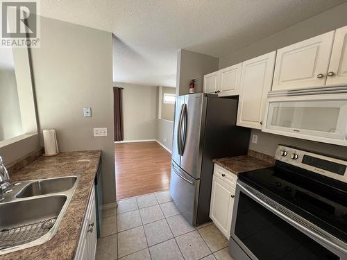 5320 Tamarack Crescent, Fort Nelson, BC - Indoor Photo Showing Kitchen With Double Sink