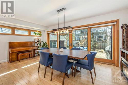 Behind the kitchen is a large dining area that features double-sliding patio doors that offer even more light. The windows also feature remote-control blinds for effortless privacy - 462 Dawson Avenue, Ottawa, ON - Indoor Photo Showing Dining Room
