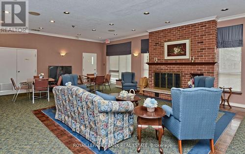#309 -4 Heritage Way, Kawartha Lakes, ON - Indoor Photo Showing Living Room With Fireplace