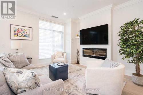 103 - 90 Orchard Point Road, Orillia, ON - Indoor Photo Showing Living Room With Fireplace