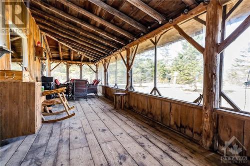 The expansive closed in porch is the perfect place to watch the wildlife while sipping your morning coffee. - 5258 Murphy Road, Calabogie, ON - Indoor Photo Showing Other Room