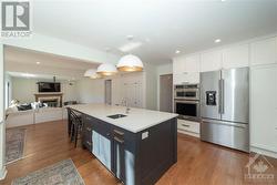 Renovated Kitchen with Custom Cabinets, Quartz Counters, Large Centre Island with Seating for 4, Stainless Steel Appliances and Hardwood Floors - 