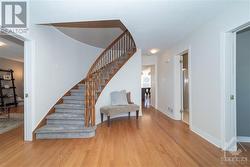 Front Hall with Hardwood Floors and Circular Staircase - 