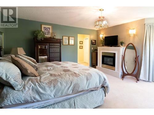 13725 Waldina Road, Prince George, BC - Indoor Photo Showing Bedroom With Fireplace