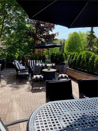 Terrace of approximately 700 sq.ft. Surrounding cedar hedge provides privacy screening and has an irrigation system - 2220 Lakeshore Road|Unit #11, Burlington, ON - Outdoor With Deck Patio Veranda