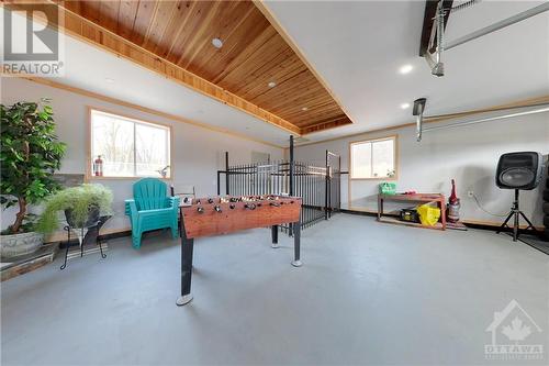 Garage interior with a built in dog pen and access to backyard - 824 Russett Drive, Arnprior, ON - Indoor