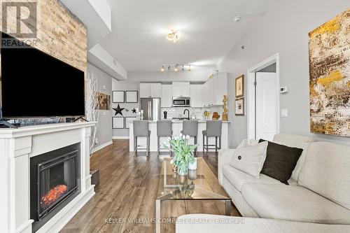 412 - 1370 Costigan Road, Milton, ON - Indoor Photo Showing Living Room With Fireplace