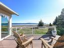 501 Arbutus Bay Rd, Fanny Bay, BC  - Outdoor With Body Of Water With Deck Patio Veranda With View With Exterior 