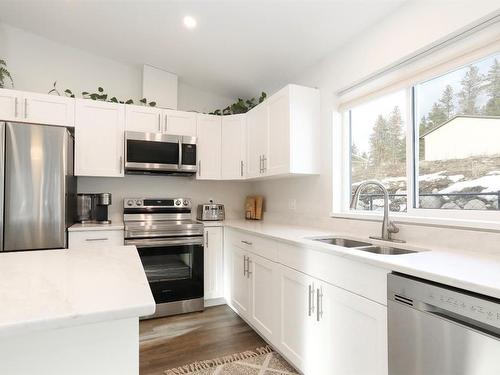 7105 Dunwaters Road, Kelowna, BC - Indoor Photo Showing Kitchen With Stainless Steel Kitchen With Double Sink