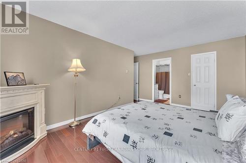 #603 -500 Talbot St, London, ON - Indoor Photo Showing Bedroom With Fireplace