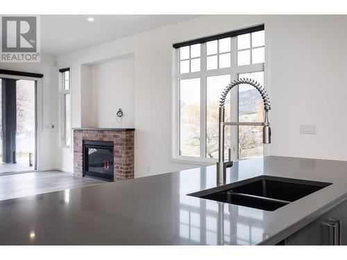 671 Ellis Street, Kelowna, BC - Indoor Photo Showing Kitchen With Fireplace