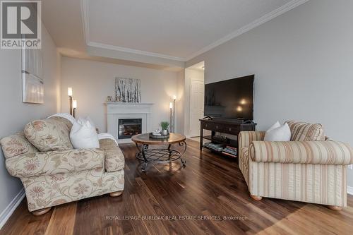 #707 -4000 Creekside Dr, Hamilton, ON - Indoor Photo Showing Living Room With Fireplace