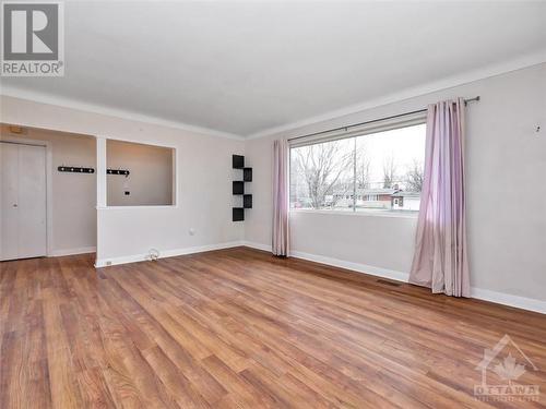 Living room with laminate hardwood floors - 5961 Perth Street, Ottawa, ON - Indoor Photo Showing Other Room