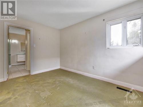 Primary bedroom with convenient 3pc. ensuite bath. Carpet underlay over plywood floors. - 5961 Perth Street, Ottawa, ON - Indoor Photo Showing Other Room