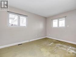 Bedroom 2 with windows on both walls. Carpet underlay over plywood floor. - 