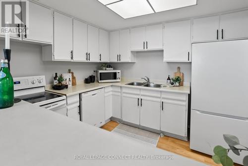 #516 -20 Dean Park Rd, Toronto, ON - Indoor Photo Showing Kitchen With Double Sink