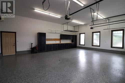 Heated garage w/built-in cabinets - 52 Greystone Close E, Brooks, AB - Indoor Photo Showing Garage