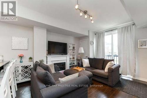 #101 -1204 Main St E, Milton, ON - Indoor Photo Showing Living Room With Fireplace