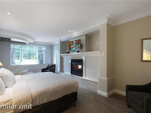 405/406A-366 Clubhouse Dr, Courtenay, BC - Indoor Photo Showing Bedroom With Fireplace