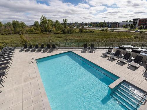 Pool - 401-3980 Boul. St-Elzear O., Laval (Chomedey), QC - Outdoor With In Ground Pool With View