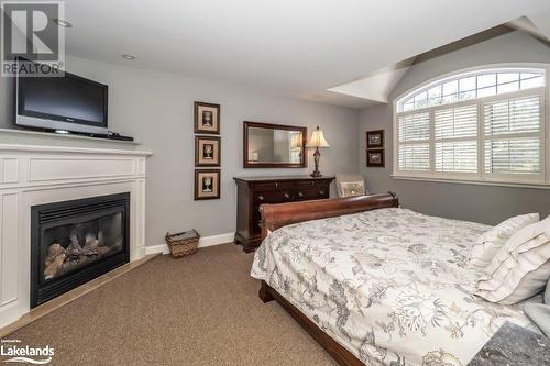 3876 Muskoka Road 118 W Unit# Carling 10-W3, Port Carling, ON - Indoor Photo Showing Bedroom With Fireplace