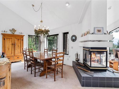 250 Channel Ridge Dr, Salt Spring, BC - Indoor Photo Showing Dining Room With Fireplace