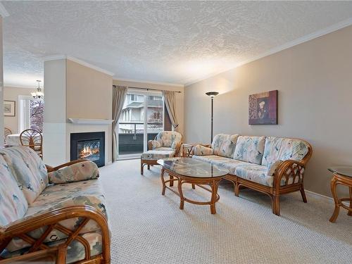 206-2349 James White Blvd, Sidney, BC - Indoor Photo Showing Living Room With Fireplace