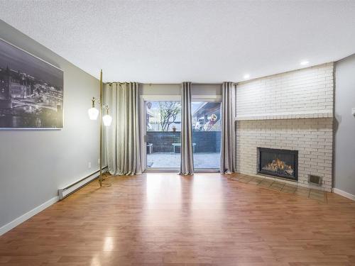 107-983 Bernard Avenue, Kelowna, BC - Indoor Photo Showing Living Room With Fireplace